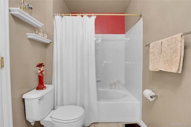 bathroom featuring tile patterned flooring, toilet, and shower / bath combo with shower curtain