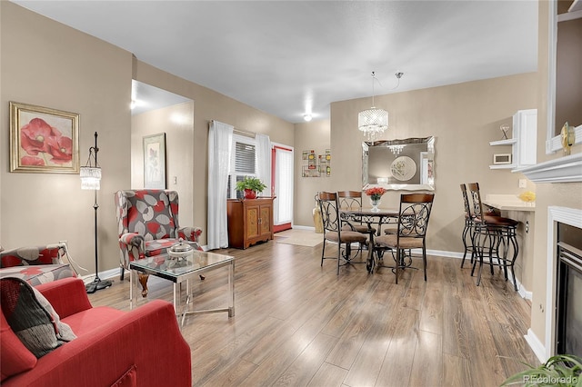 living room with a notable chandelier and light hardwood / wood-style floors