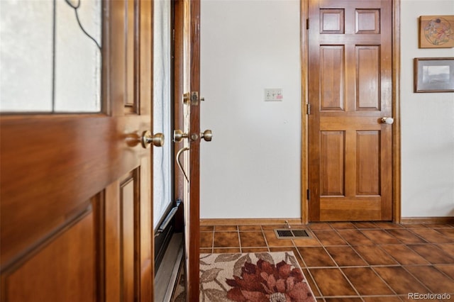 5245 Sapphire Dr, Colorado Springs, CO 80918 - foyer with baseboards and dark tile patterned floors
