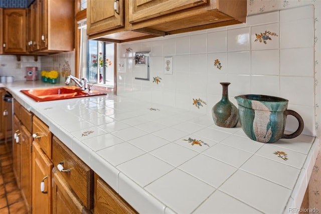5245 Sapphire Dr, Colorado Springs, CO 80918 - kitchen featuring a sink, brown cabinets, and backsplash