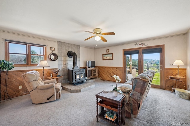 5245 Sapphire Dr, Colorado Springs, CO 80918 - living room featuring wooden walls, plenty of natural light, wainscoting, carpet flooring, and a ceiling fan