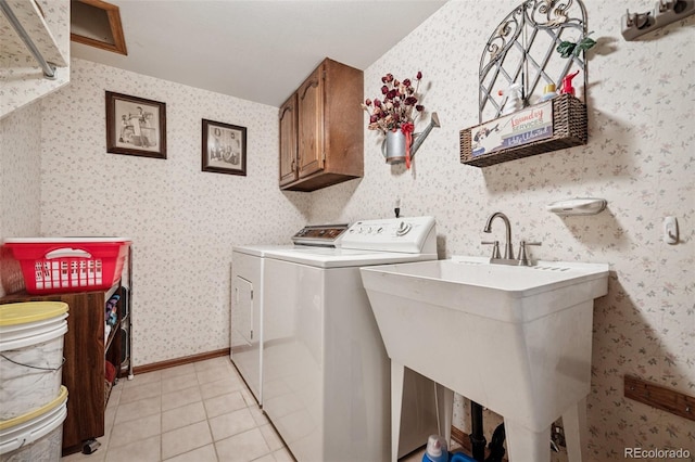 5245 Sapphire Dr, Colorado Springs, CO 80918 - laundry room featuring cabinet space, light tile patterned floors, wallpapered walls, and separate washer and dryer