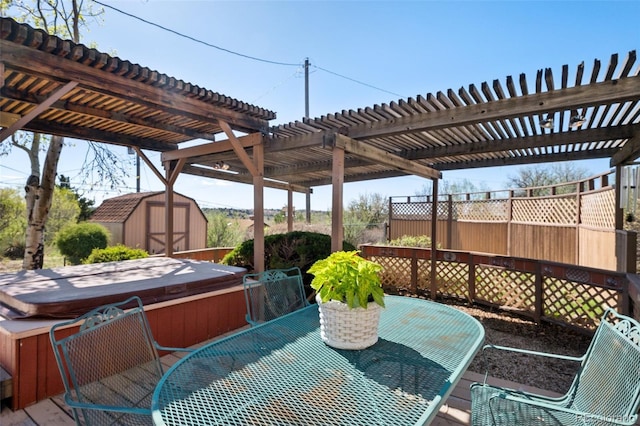 5245 Sapphire Dr, Colorado Springs, CO 80918 - wooden deck featuring a hot tub, outdoor dining space, a storage shed, and a pergola