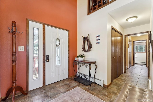 foyer featuring a baseboard radiator and baseboards