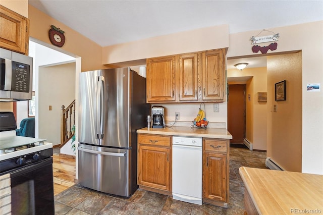 kitchen with stainless steel appliances, a baseboard radiator, brown cabinetry, and light countertops