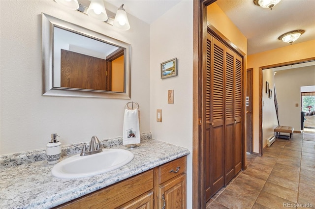 bathroom with a baseboard heating unit and vanity