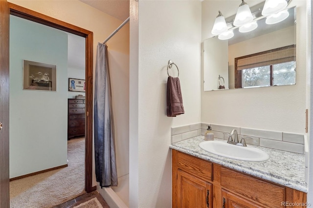 full bathroom with baseboards, vanity, and a shower with curtain