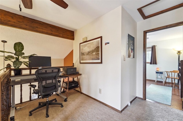 home office featuring lofted ceiling with beams, carpet, a ceiling fan, and baseboards