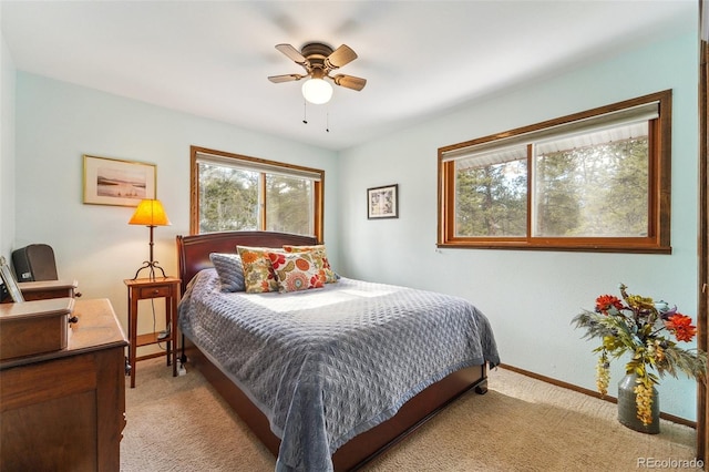 bedroom featuring light carpet, ceiling fan, and baseboards