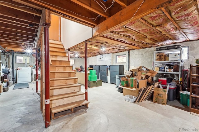 basement featuring stairs and washer / dryer