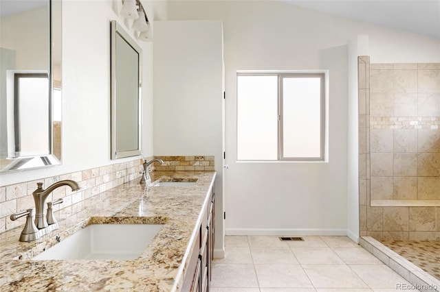 7551 S Garland St, Littleton, CO 80128 - bathroom featuring double vanity, vaulted ceiling, and tile patterned floors