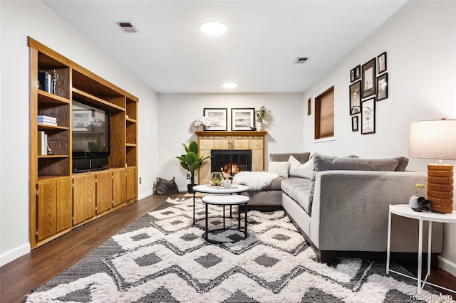 7551 S Garland St, Littleton, CO 80128 - living area with dark wood finished floors, a tile fireplace, and recessed lighting