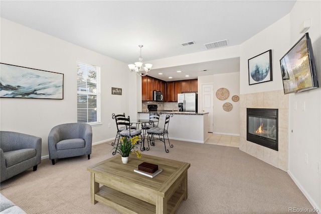 16179 E Geddes Ln Unit 96, Aurora, CO 80016 - living area featuring light carpet, a chandelier, a tiled fireplace, and recessed lighting