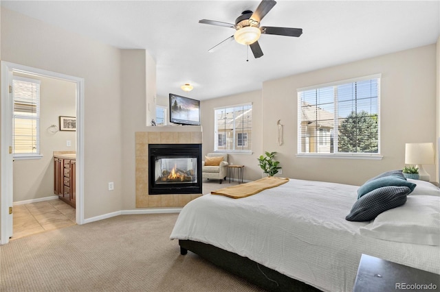 16179 E Geddes Ln Unit 96, Aurora, CO 80016 - bedroom with a tile fireplace, light colored carpet, ensuite bath, and ceiling fan