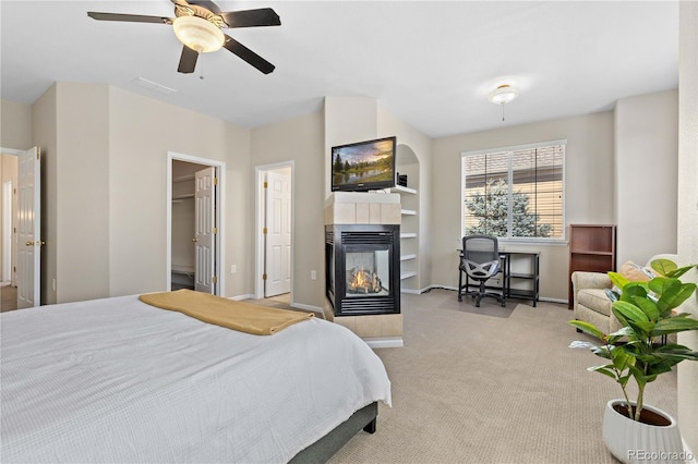 16179 E Geddes Ln Unit 96, Aurora, CO 80016 - carpeted bedroom with a tile fireplace, ceiling fan, and a walk in closet