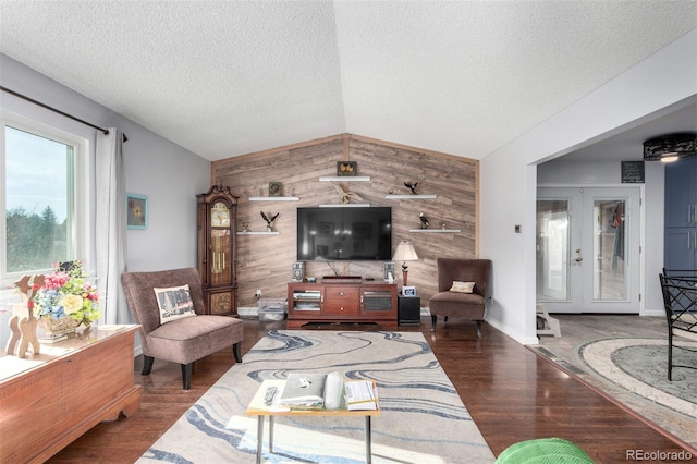 living area with vaulted ceiling, french doors, wood finished floors, and wood walls