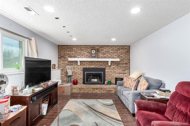 living room with visible vents, a textured ceiling, dark wood finished floors, recessed lighting, and a fireplace