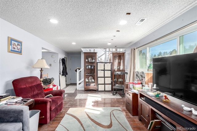 living room with visible vents, recessed lighting, a textured ceiling, and stairs