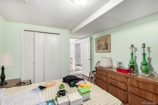 bedroom featuring a closet, a textured ceiling, and wood finished floors