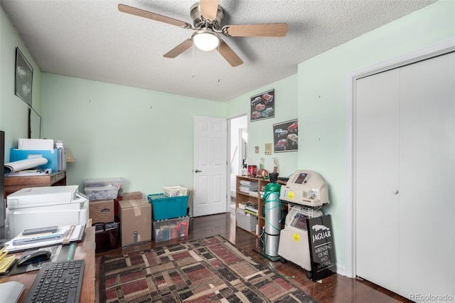 interior space featuring a textured ceiling, wood finished floors, and a ceiling fan