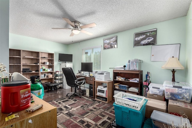 office area featuring a textured ceiling, dark wood-style flooring, and a ceiling fan