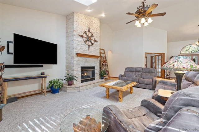 living room featuring ceiling fan, lofted ceiling, a fireplace, and carpet floors