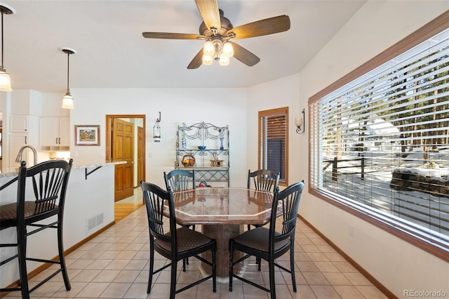 dining room with light tile patterned flooring and ceiling fan