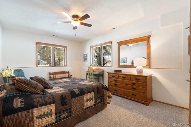 carpeted bedroom with multiple windows and ceiling fan