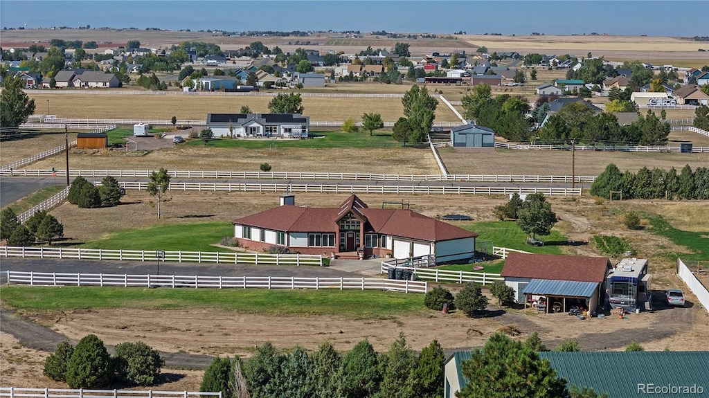 birds eye view of property with a rural view