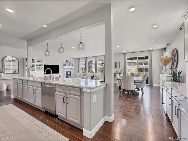 14565 Vancouver Pl, Parker, CO 80134 - kitchen with dishwasher, dark wood-type flooring, open floor plan, light stone counters, and recessed lighting