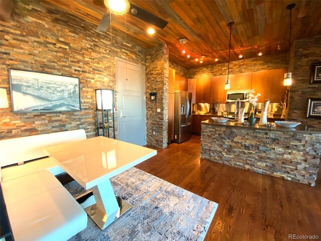 10111 Inverness Main St Unit 223, Englewood, CO 80112 - kitchen featuring stainless steel appliances, wooden ceiling, dark wood finished floors, a ceiling fan, and decorative light fixtures
