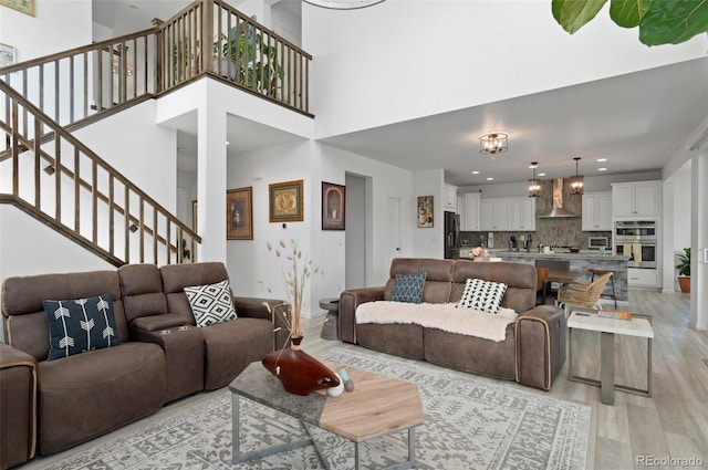 6454 Leathers Ln, Parker, CO 80134 - living room featuring light wood-type flooring, stairs, and recessed lighting