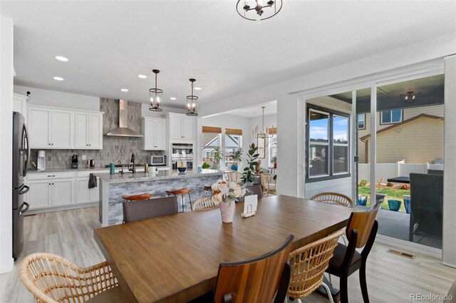 6454 Leathers Ln, Parker, CO 80134 - dining space with recessed lighting, light wood-style floors, and a chandelier