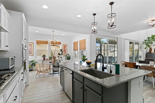6454 Leathers Ln, Parker, CO 80134 - kitchen featuring a chandelier, appliances with stainless steel finishes, a kitchen island with sink, recessed lighting, and light wood finished floors