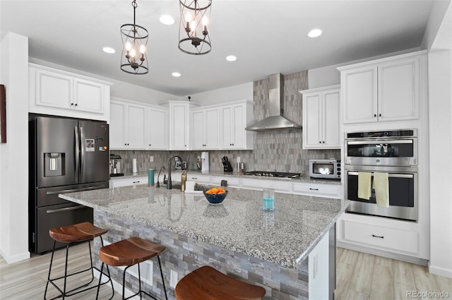 6454 Leathers Ln, Parker, CO 80134 - kitchen with appliances with stainless steel finishes, wall chimney exhaust hood, white cabinetry, tasteful backsplash, and recessed lighting