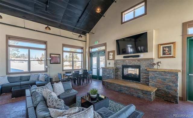6454 Leathers Ln, Parker, CO 80134 - living room with high vaulted ceiling, a stone fireplace, and french doors
