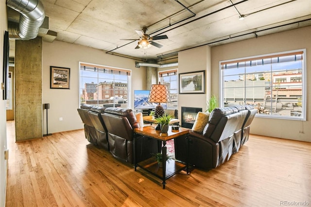 living room featuring ceiling fan and light wood-type flooring