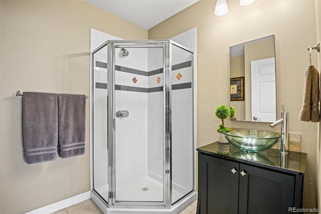 bathroom featuring tile patterned flooring, vanity, and walk in shower