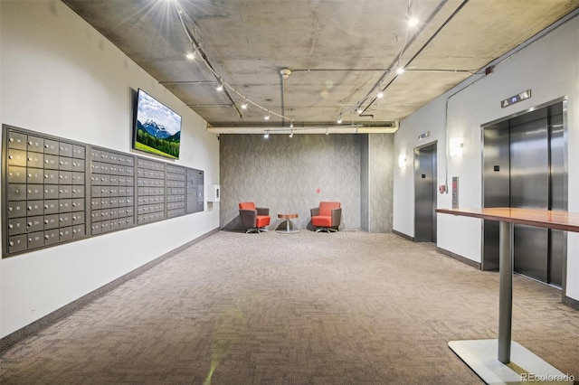 game room with elevator, rail lighting, carpet floors, and mail boxes