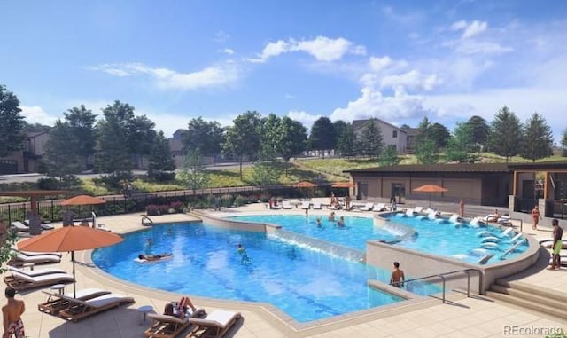 community pool with a patio and fence