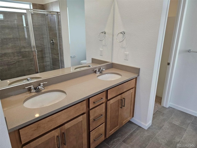full bath with a shower stall, toilet, and double vanity