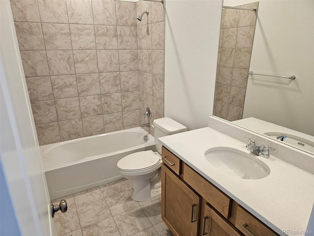 bathroom featuring toilet, tub / shower combination, vanity, and a textured wall