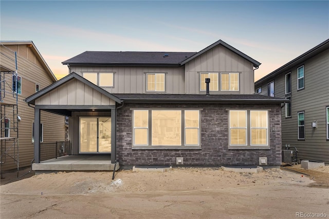 6683 Bridle Creek Pt, Castle Pines, CO 80108 - view of front facade with board and batten siding and covered porch