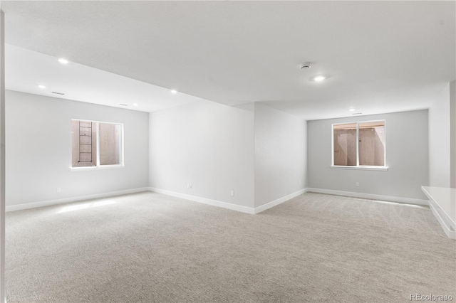 6683 Bridle Creek Pt, Castle Pines, CO 80108 - empty room featuring light carpet, recessed lighting, a smoke detector, and plenty of natural light