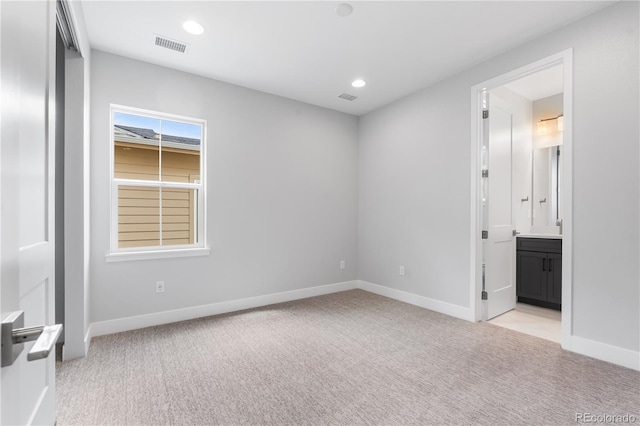 6683 Bridle Creek Pt, Castle Pines, CO 80108 - unfurnished bedroom featuring light colored carpet, connected bathroom, and recessed lighting