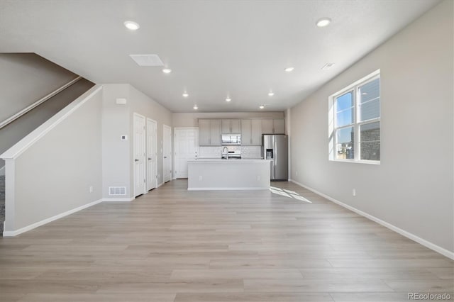 unfurnished living room with light wood-type flooring