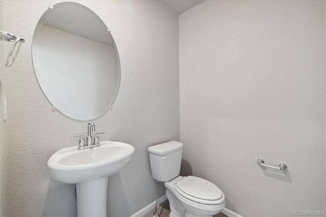 bathroom featuring sink and toilet