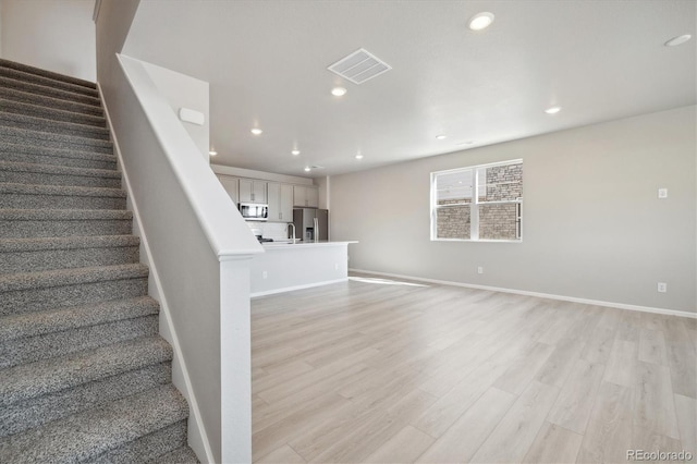 staircase featuring hardwood / wood-style floors