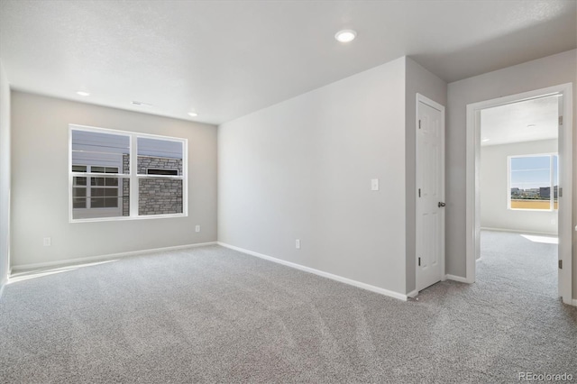 empty room with light colored carpet