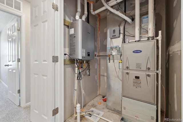 utility room with tankless water heater and heating unit